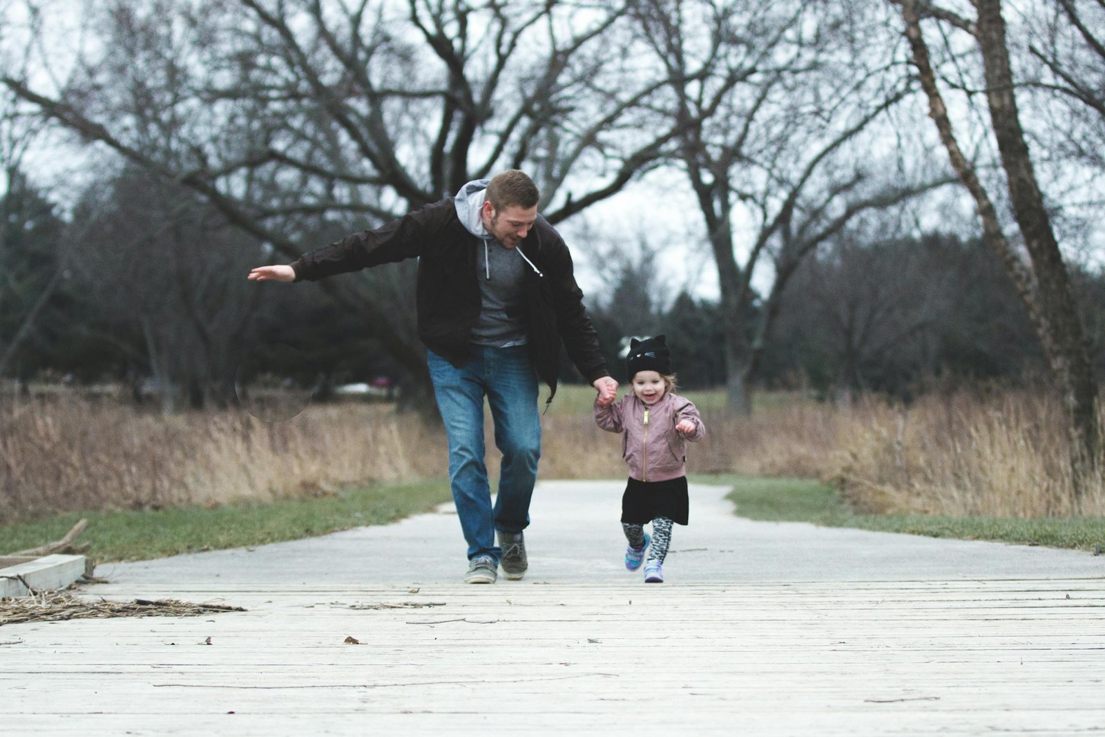 Dad and daughter enjoying a walk in the park, symbolizing love and togetherness.